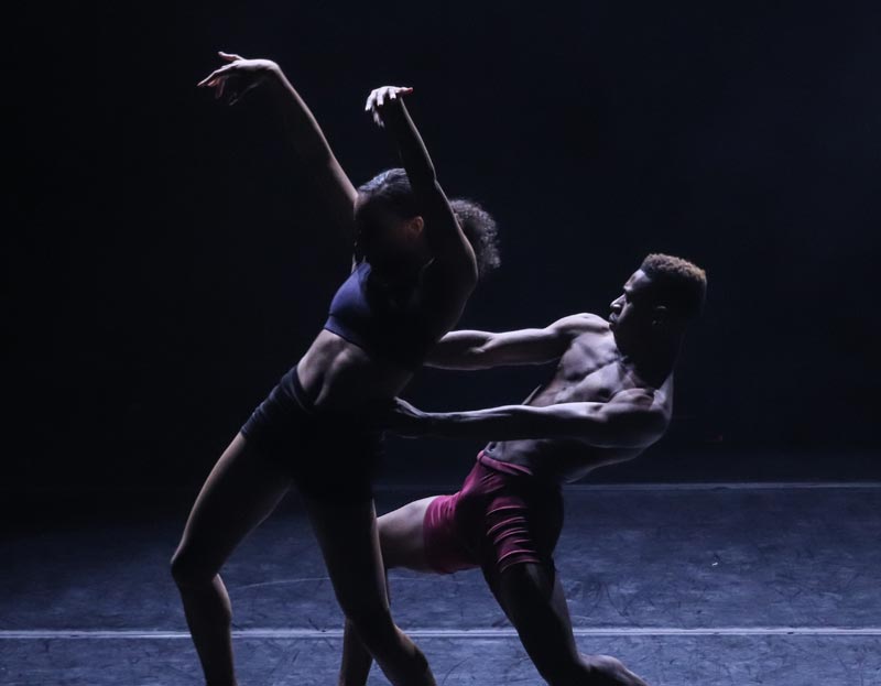 Two students perform a dance together on stage